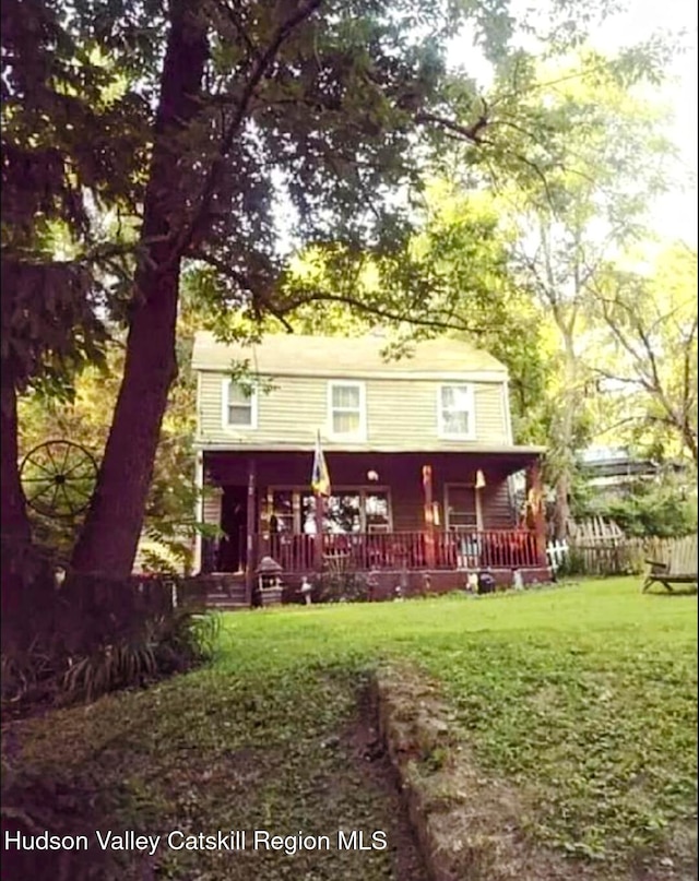 4 Tanners Ln, Hudson, NY 12534 - rear view of house with a porch and a lawn