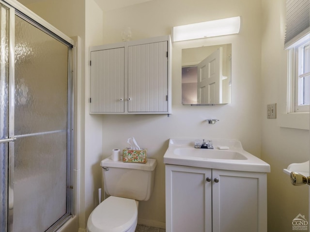 bathroom featuring an enclosed shower, vanity, and toilet