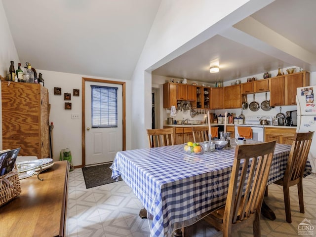 dining area featuring lofted ceiling