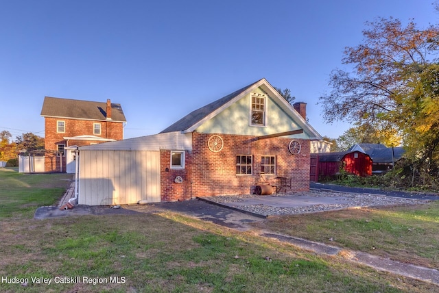back of house with a yard and a patio