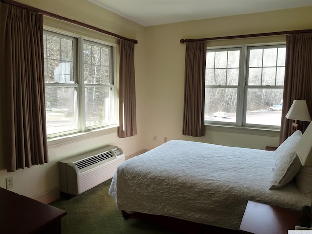 62 Liftside Dr Unit 432K4, Hunter, NY 12442 - bedroom featuring an AC wall unit, multiple windows, and dark carpet