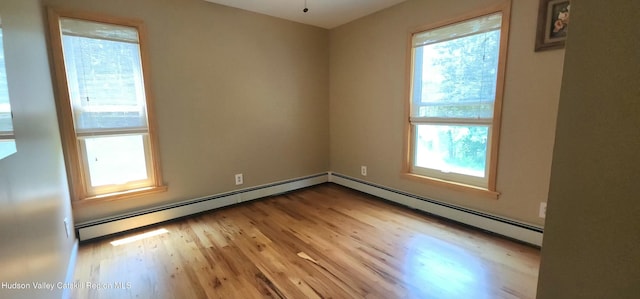 273 E Conesville Rd, Conesville, NY 12076 - unfurnished room with healthy amount of natural light, light wood-style flooring, and a baseboard heating unit
