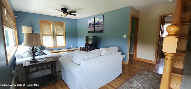 273 E Conesville Rd, Conesville, NY 12076 - living room with a baseboard radiator, wood finished floors, and ceiling fan
