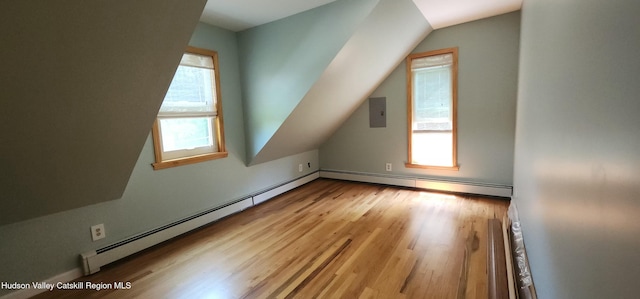 273 E Conesville Rd, Conesville, NY 12076 - bonus room with baseboard heating, wood finished floors, vaulted ceiling, and healthy amount of natural light