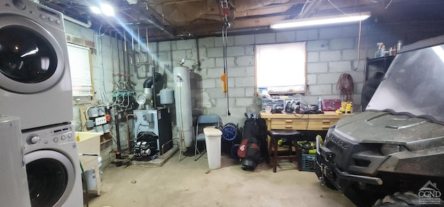 273 E Conesville Rd, Conesville, NY 12076 - below grade area featuring stacked washer / dryer, a workshop area, and concrete block wall