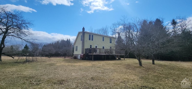273 E Conesville Rd, Conesville, NY 12076 - view of side of property with a chimney, a deck, and a yard