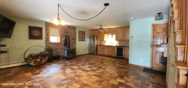 273 E Conesville Rd, Conesville, NY 12076 - kitchen with beverage cooler, freestanding refrigerator, a wood stove, dark countertops, and a ceiling fan