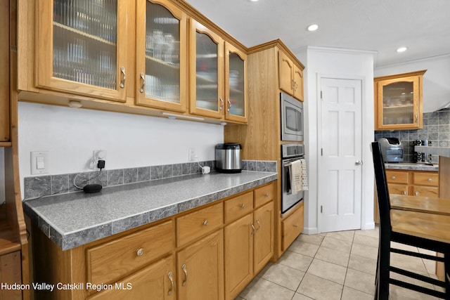 8 Orlich Rd, Red Hook, NY 12571 - kitchen featuring appliances with stainless steel finishes, glass insert cabinets, light tile patterned flooring, tasteful backsplash, and recessed lighting