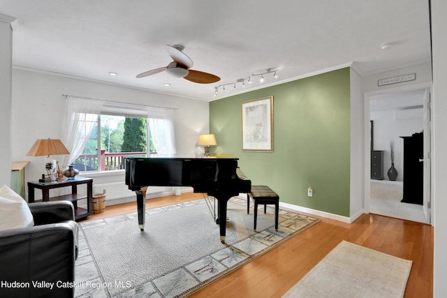 8 Orlich Rd, Red Hook, NY 12571 - living area with crown molding, wood-type flooring, ceiling fan, track lighting, and baseboards
