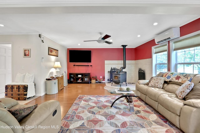 8 Orlich Rd, Red Hook, NY 12571 - living room featuring a wood stove, an AC wall unit, wood finished floors, a ceiling fan, and recessed lighting