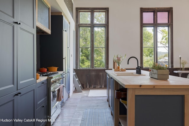 150 Blenheim Hill Rd, Jefferson, NY 12093 - kitchen with stainless steel range, open shelves, healthy amount of natural light, and a kitchen island with sink