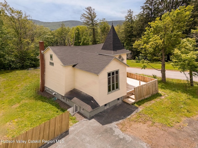 150 Blenheim Hill Rd, Jefferson, NY 12093 - view of side of property with a shingled roof, a chimney, a yard, and a view of trees