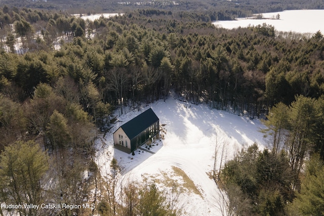 snowy aerial view with a forest view