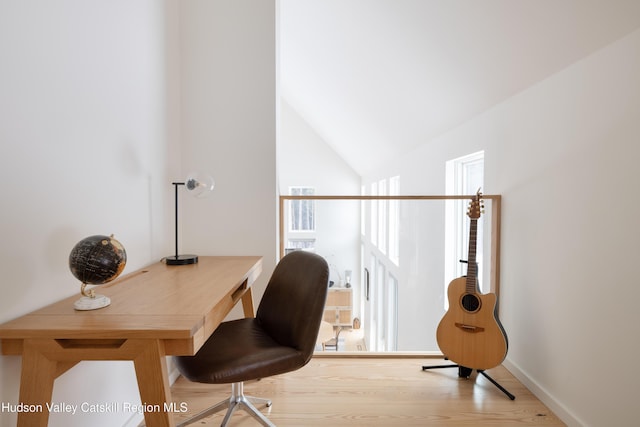 office featuring vaulted ceiling, baseboards, and wood finished floors