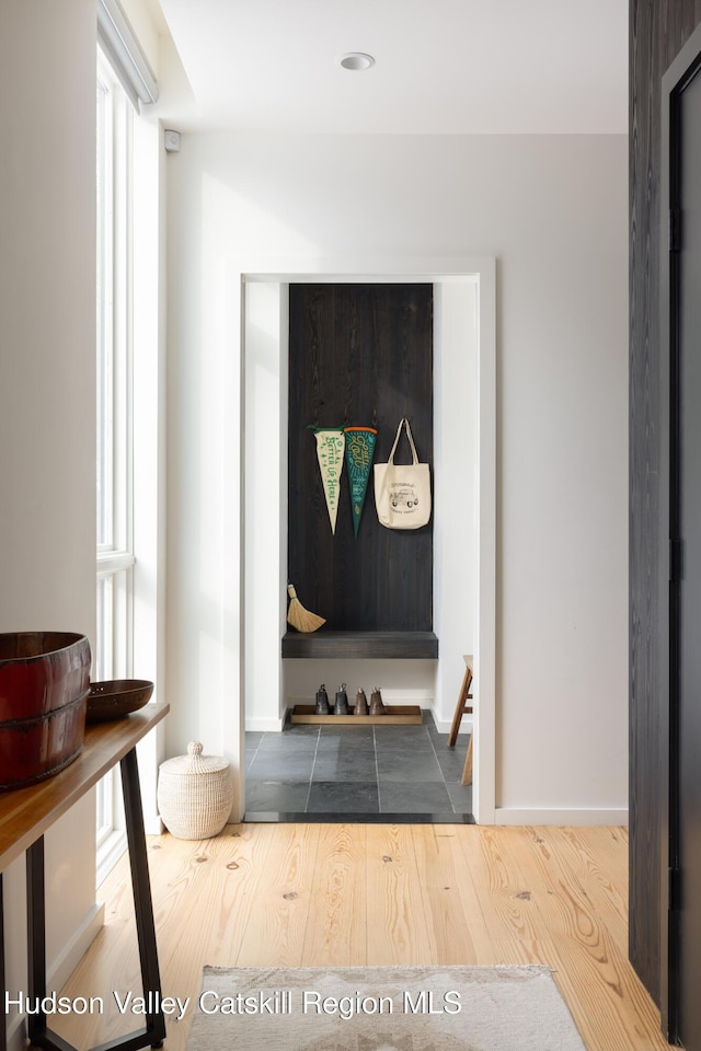 interior space featuring baseboards and wood finished floors