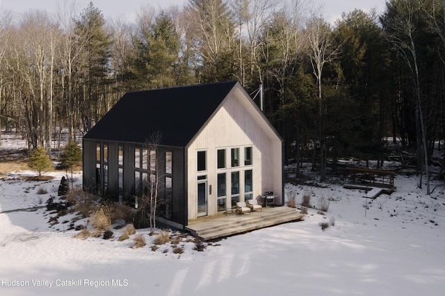 snow covered structure featuring an outdoor structure