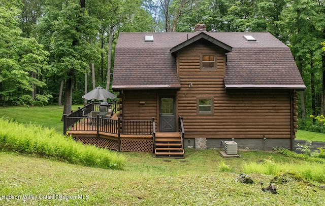 1206 Hollow Rd, Clinton, NY 12514 - back of house with a shingled roof, a deck, a chimney, log siding, and a yard