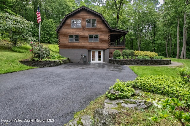 1206 Hollow Rd, Clinton, NY 12514 - rear view of house with french doors, log exterior, a lawn, and asphalt driveway