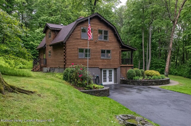 1206 Hollow Rd, Clinton, NY 12514 - view of side of home featuring french doors, a lawn, asphalt driveway, a gambrel roof, and log siding