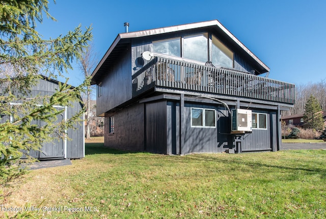 rear view of property with a lawn and a balcony