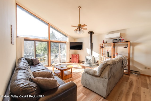 living room with a wood stove, high vaulted ceiling, light hardwood / wood-style flooring, ceiling fan, and a wall mounted AC