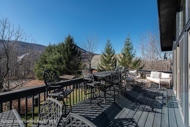 deck with a mountain view and an outdoor hangout area