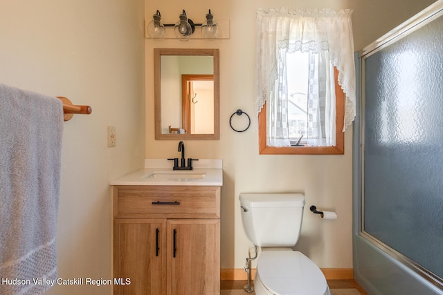 full bathroom featuring vanity, toilet, and enclosed tub / shower combo