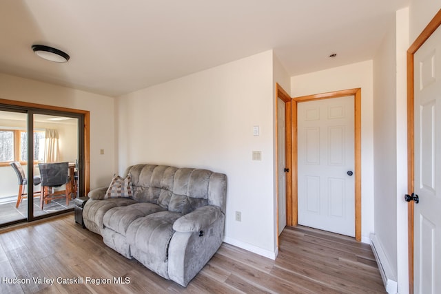 sitting room with hardwood / wood-style floors and a baseboard radiator