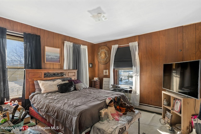 bedroom featuring multiple windows, light colored carpet, and wood walls