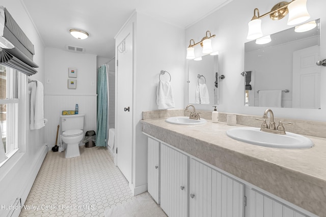 full bath with toilet, visible vents, baseboard heating, and a sink