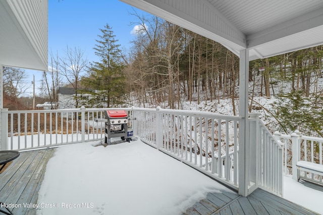 snow covered deck featuring a grill