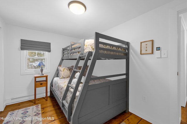 bedroom with dark wood finished floors and baseboards