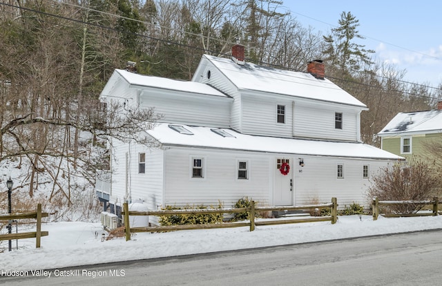 view of front of house featuring a chimney