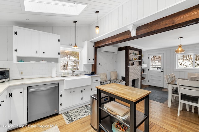 kitchen with a wall unit AC, a sink, appliances with stainless steel finishes, open shelves, and pendant lighting