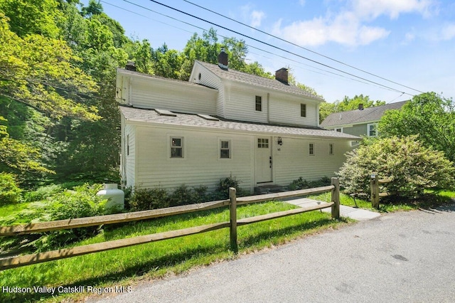 view of front of property with fence and a chimney