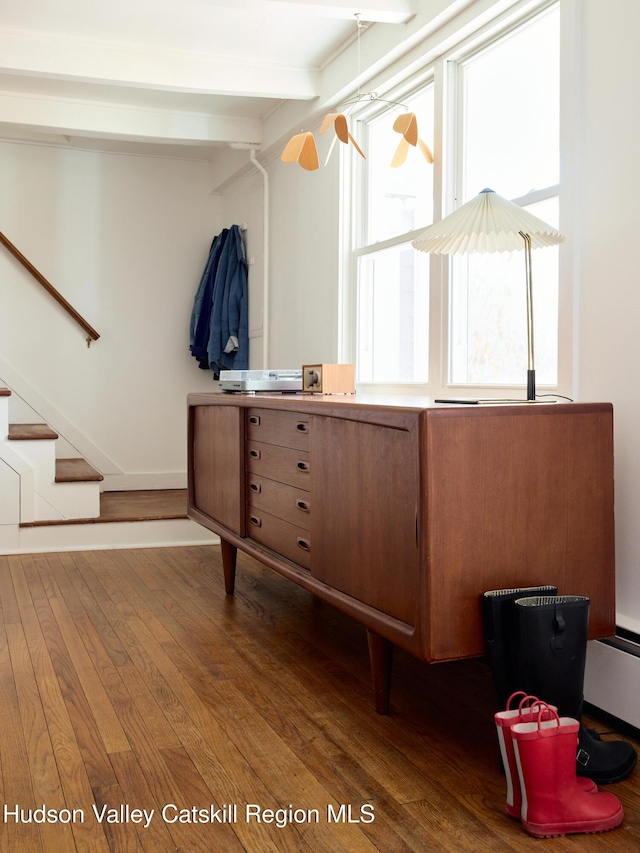 interior space featuring wood finished floors and beamed ceiling