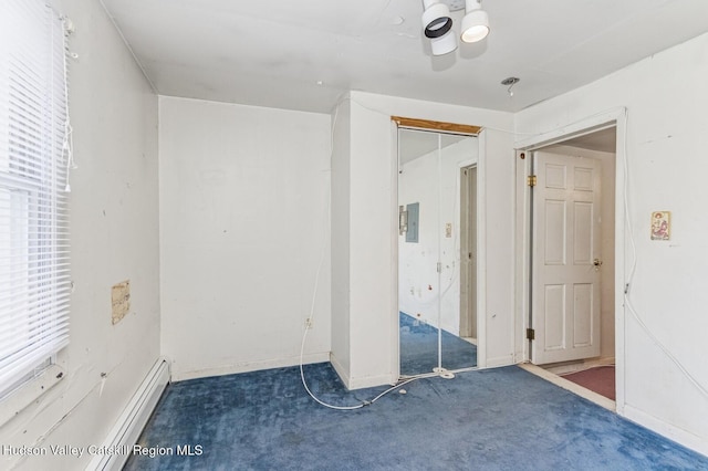 unfurnished bedroom featuring a baseboard heating unit and carpet floors