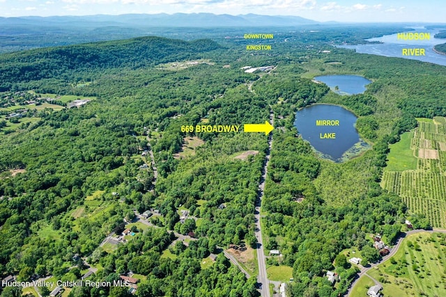 bird's eye view with a forest view and a water and mountain view