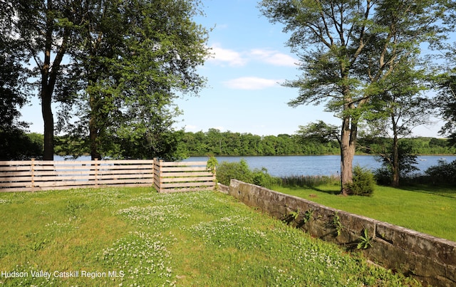 view of yard featuring fence and a water view