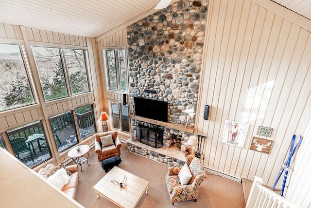 carpeted living area with lofted ceiling, wooden walls, a fireplace, and wood ceiling