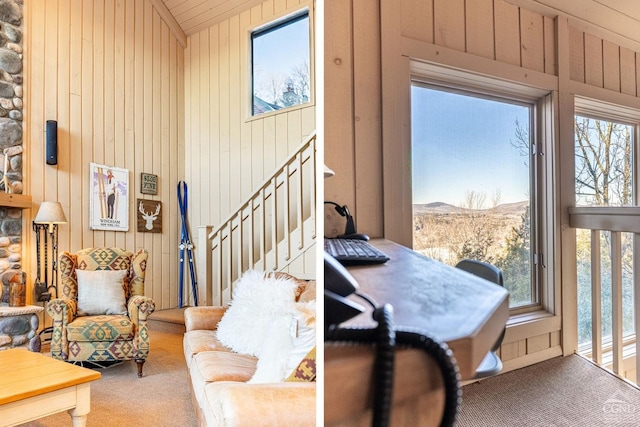living area with carpet flooring, wooden walls, vaulted ceiling, and a mountain view