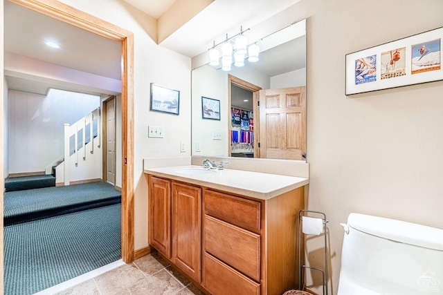 bathroom with vanity, toilet, and tile patterned flooring