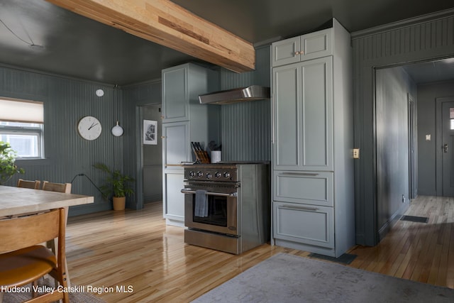 kitchen with gray cabinets, light wood-type flooring, and high end stainless steel range oven