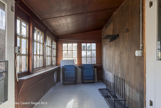 unfurnished sunroom with plenty of natural light, wood ceiling, and vaulted ceiling