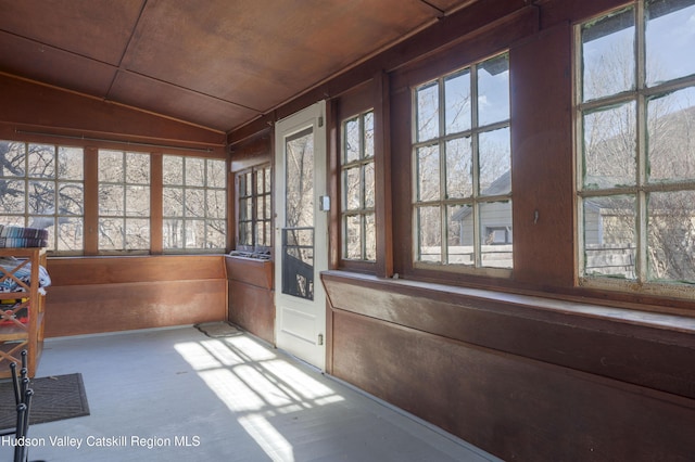 unfurnished sunroom featuring plenty of natural light, lofted ceiling, and wood ceiling