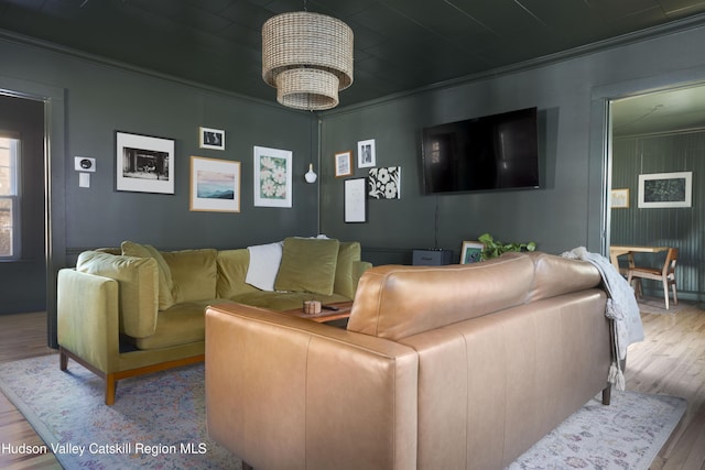 living room featuring light hardwood / wood-style floors and crown molding