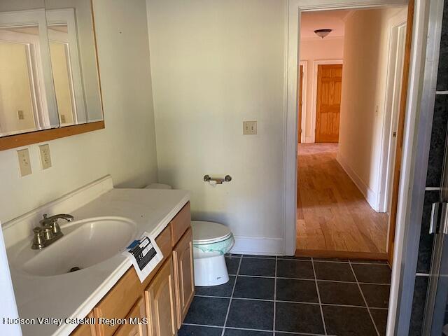 bathroom with tile patterned floors, vanity, and toilet