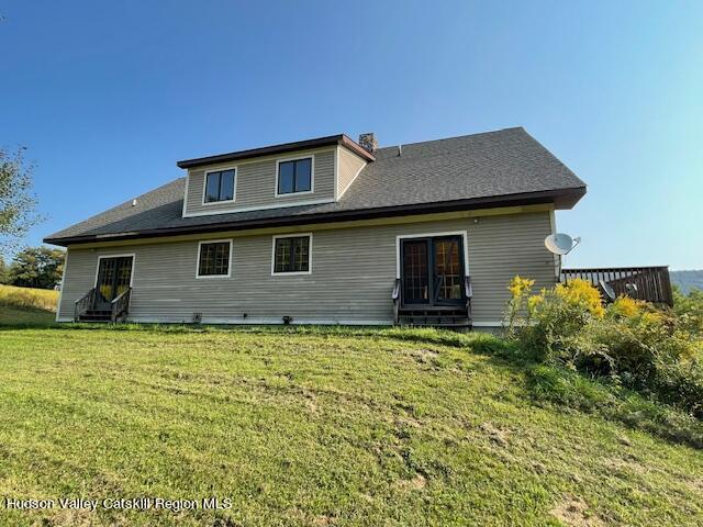 rear view of house with a lawn