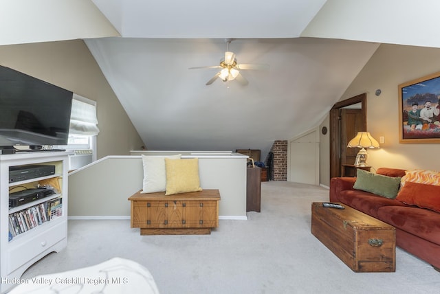 interior space featuring vaulted ceiling, carpet, and a ceiling fan