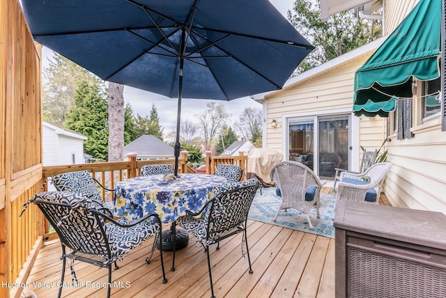 wooden deck with outdoor dining area